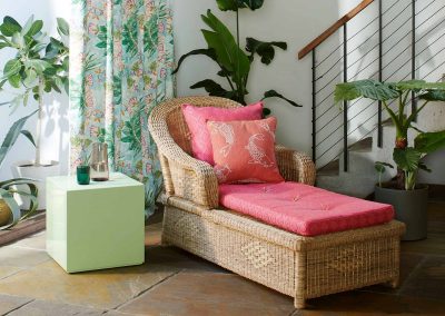 lounge chair on a tiled floor with pink cushions