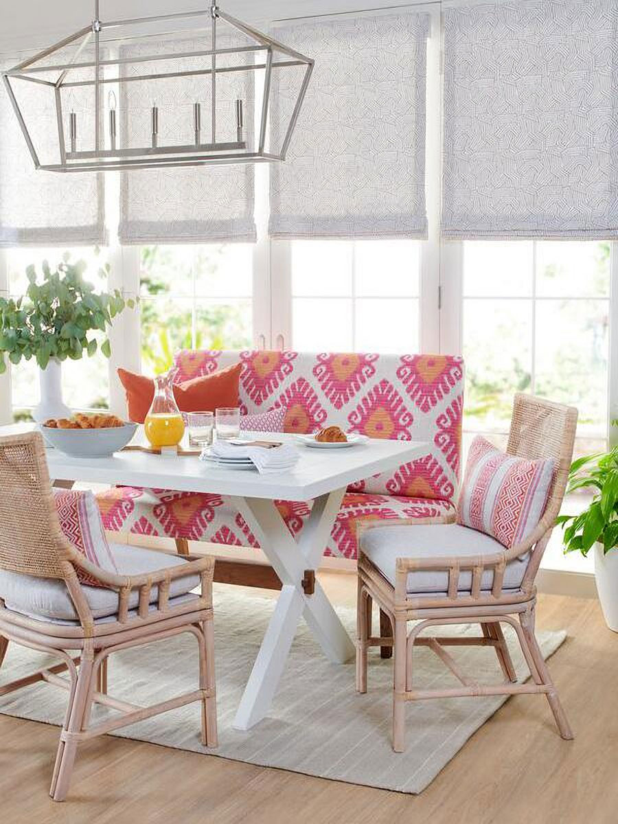 roman-shade red and patterned curtain in front of a closed window with white walls